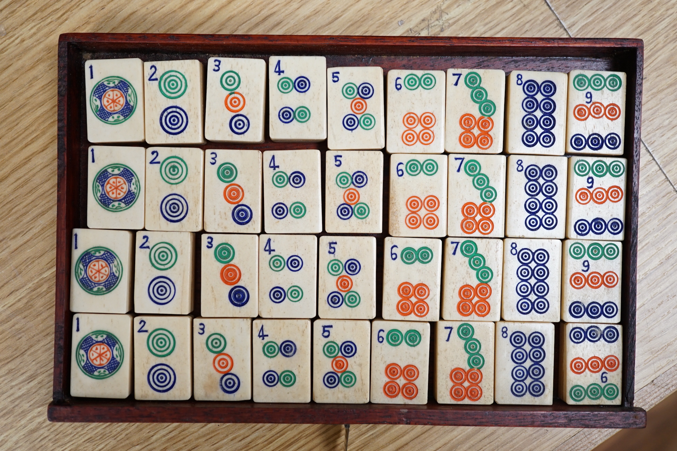 A Chinese Mah-Jong set in hardwood case with bone pieces